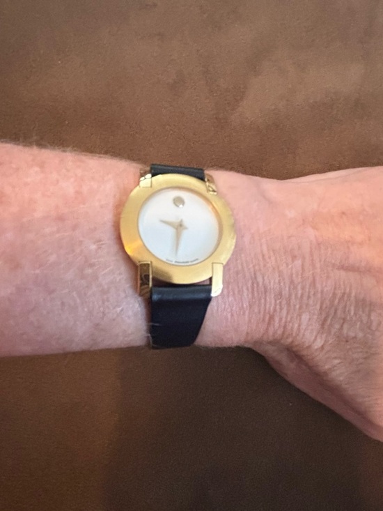 Movado Accessories - Movado gold tone women’s watch with black leather strap.